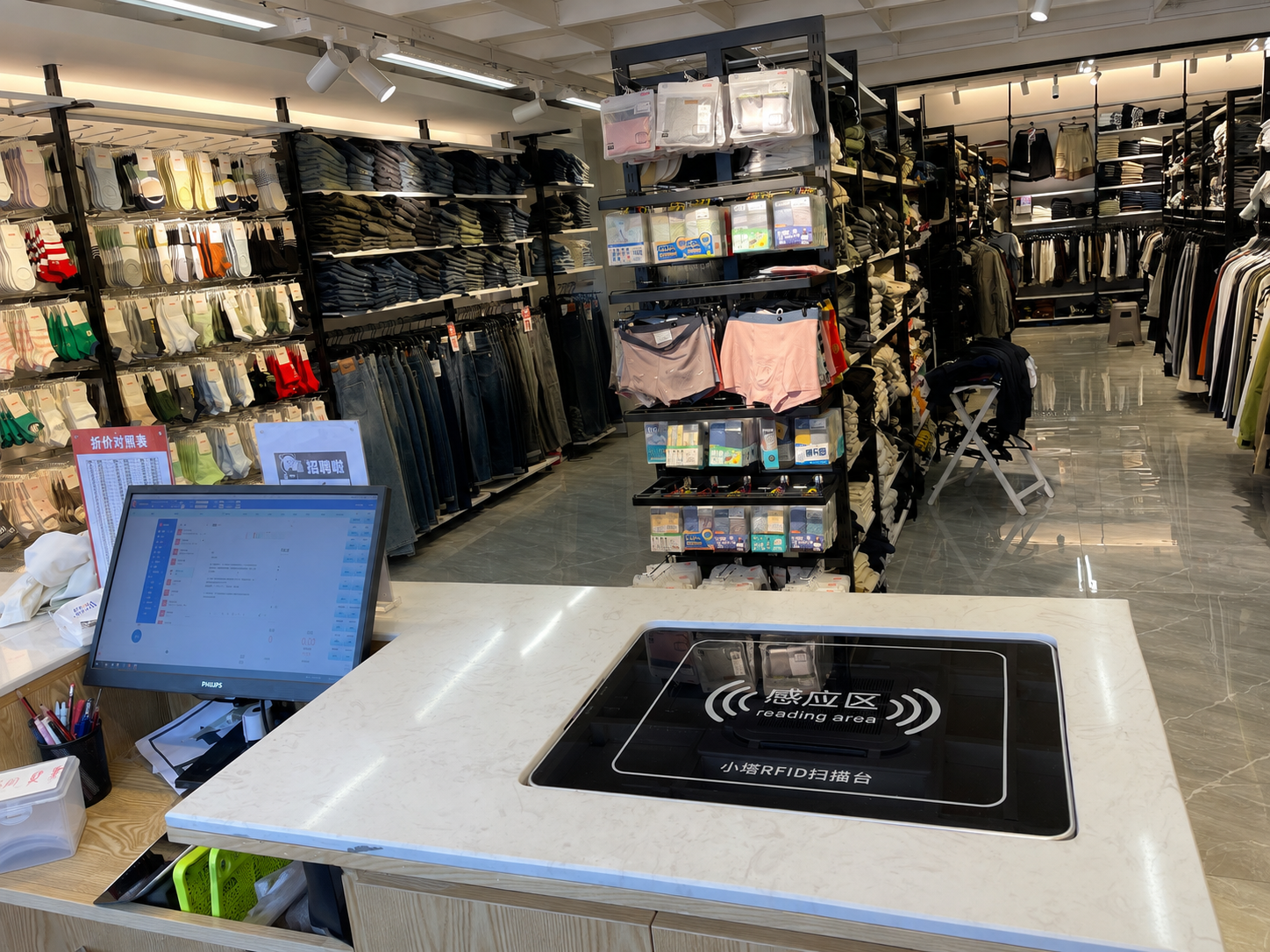 Multiple RFID-tagged garments placed on XTS2002 at a fashion retail checkout